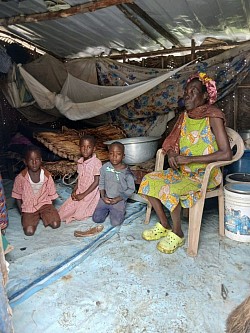 Young orphans and their grandmother in their shelter